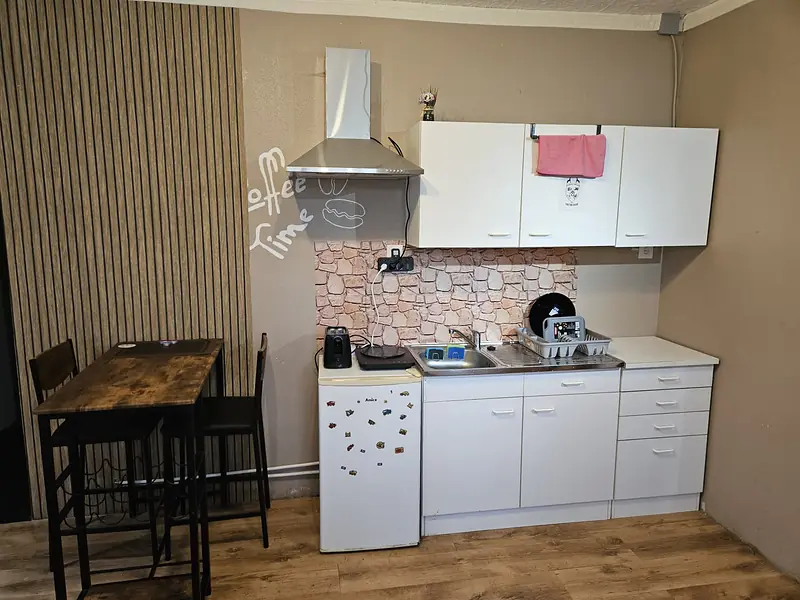Kitchenette and bar table with two bar stools