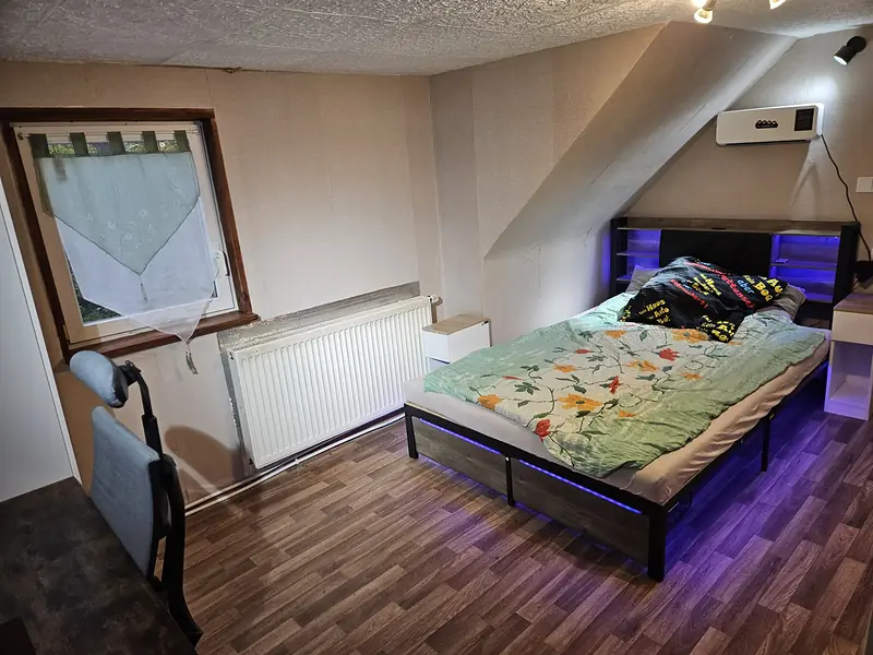 LED-lit bed under the sloping ceiling