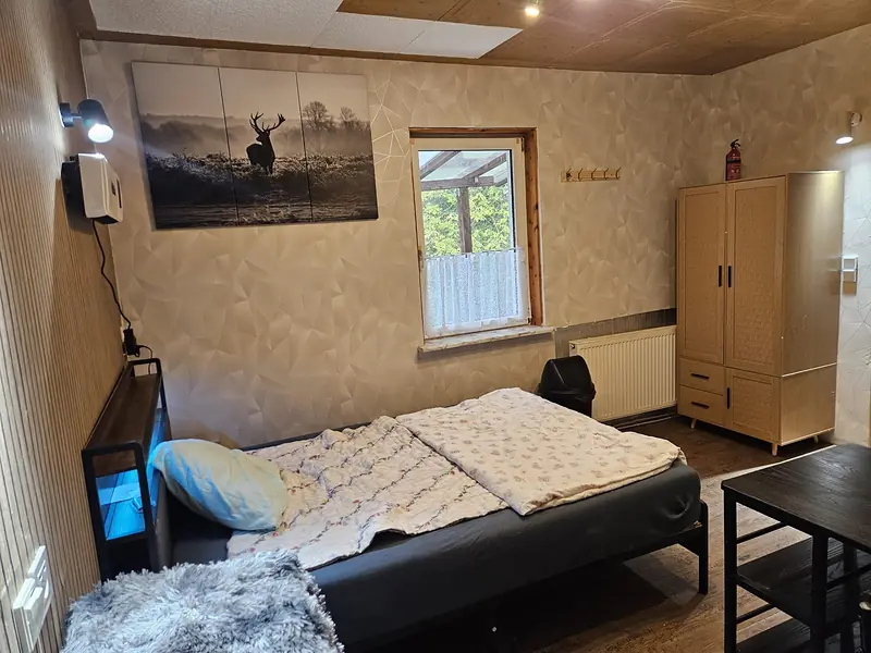 Bed, wardrobe and window onto the terrace